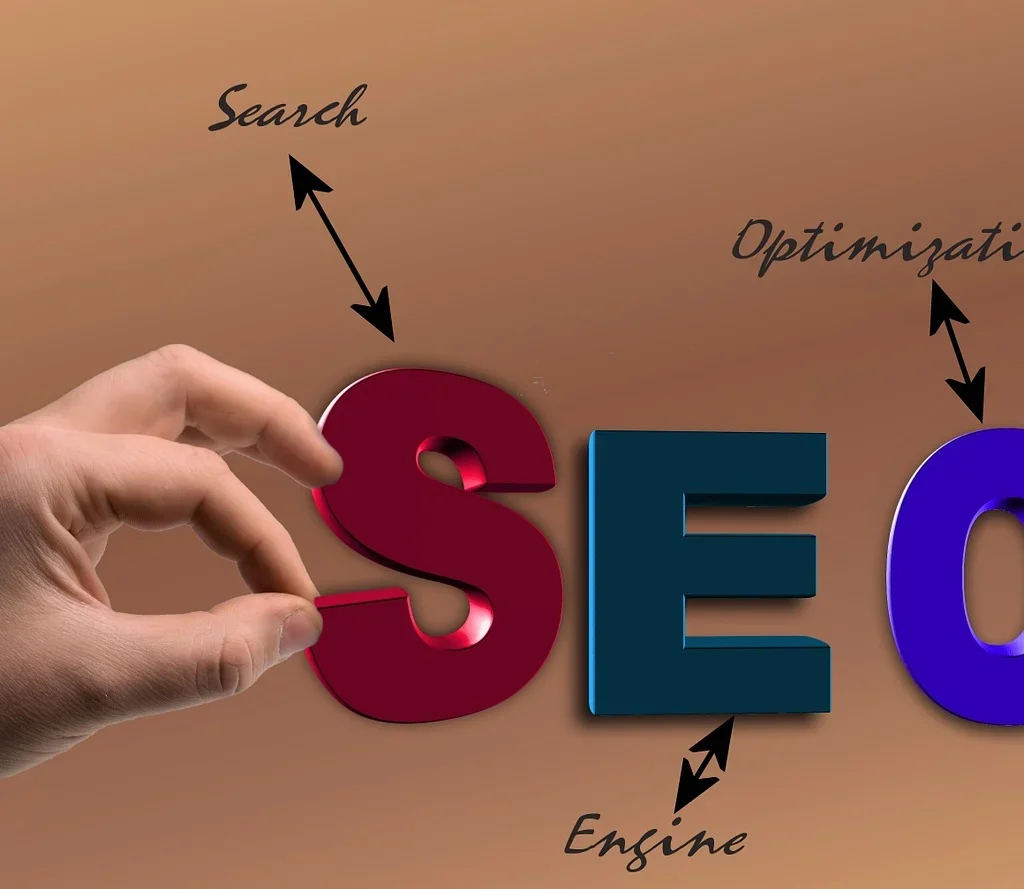 Enginefirm.com: Top Tips for Building a Strong Backlink Profile A hand holding the letter "S" from the word "SEO," which stands for Search Engine Optimization. Arrows point to the words "Search," "Engine," and "Optimization" around the letters, symbolizing the core elements of SEO.