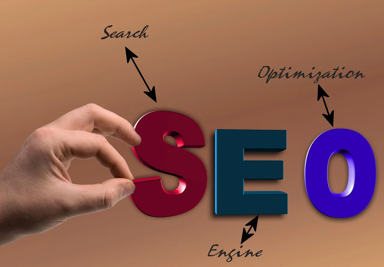 Enginefirm.com: Top Tips for Building a Strong Backlink Profile A hand holding the letter "S" from the word "SEO," which stands for Search Engine Optimization. Arrows point to the words "Search," "Engine," and "Optimization" around the letters, symbolizing the core elements of SEO.