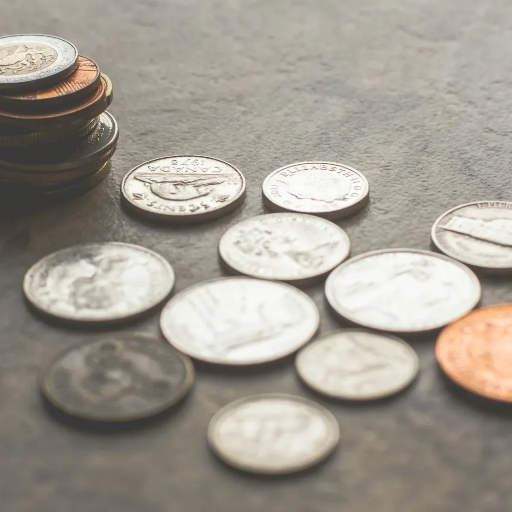 An assortment of coins on a surface, symbolizing the financial scrutiny and resource allocation that would be evaluated during a Nonprofit Marketing Audit."