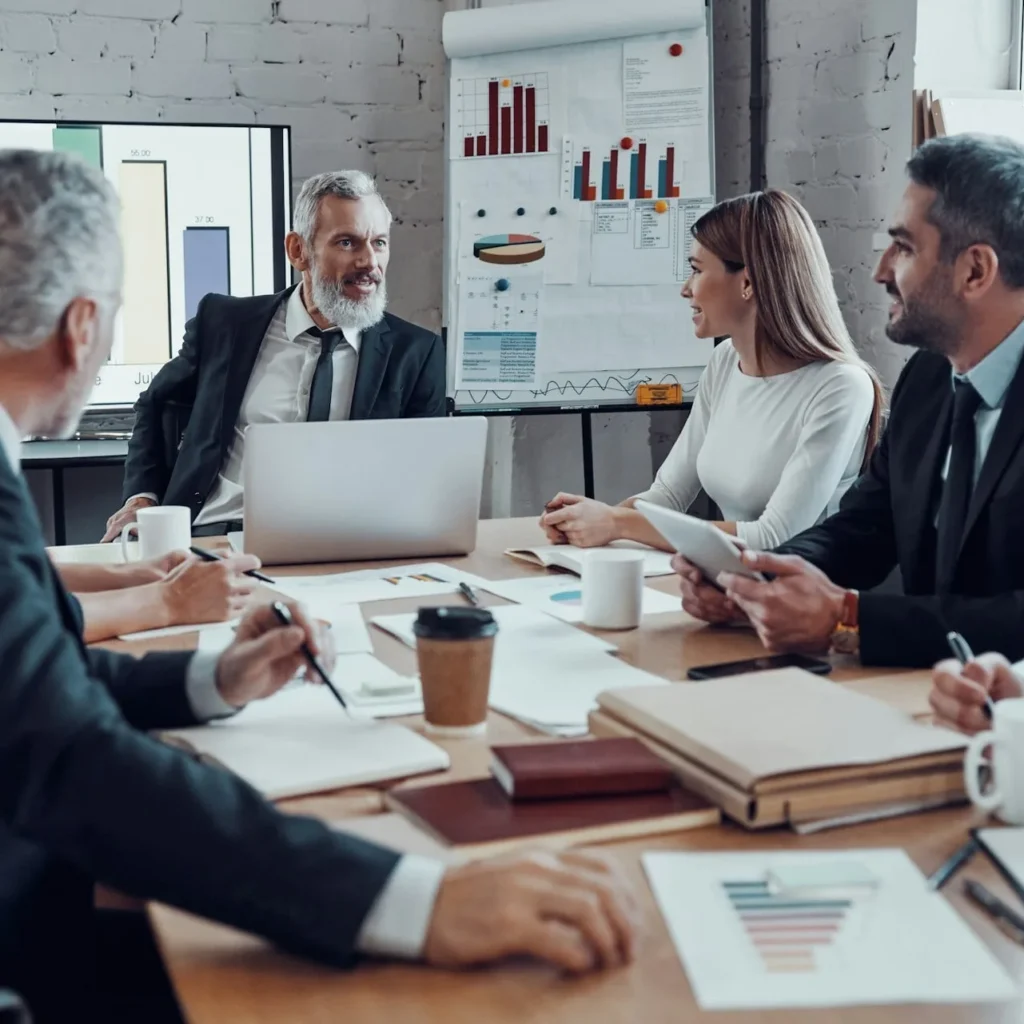 Business meeting focused on Inbound Marketing for B2B Companies, showing a group of professionals around a conference table."